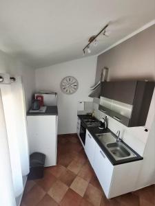 a small kitchen with a sink and a stove at Bay view apartment in Bakar +11 photos