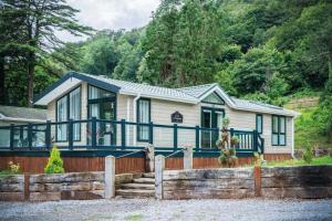 a house with a blue and white at 2 Manor Lodge - 2 Bedroom Lodge - Pendine in Pendine