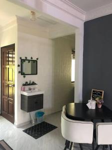 ein Badezimmer mit einem Waschbecken, einem Tisch und einem Spiegel in der Unterkunft Village Homestay Kuala Besut near Perhentian Island Jetty in Kampong Baru