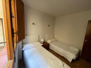 a small room with two beds in it at Sego Apartments I in Segovia