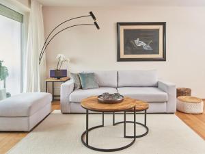 a living room with a couch and a table at Techts Apartmenthaus in Timmendorfer Strand