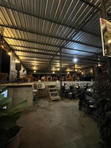 a large room with a ceiling and a room with chairs at Dragonfly Senaru Lodge in Senaru +32 photos