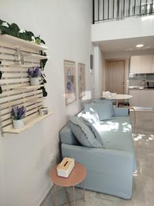 a living room with a blue couch and a table at Liana's Stylish House in Kalabaka