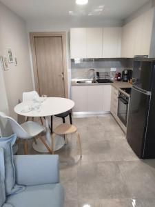 a kitchen with a table and chairs and a refrigerator at Liana's Stylish House in Kalabaka