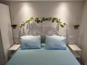 a bed with a metal headboard with plants on it at Liana's Stylish House in Kalabaka