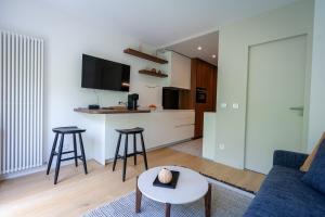 a living room with a couch and a table at Lac & Nest in Annecy