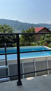 a swimming pool on the balcony of a house at Casa Ema in Orşova