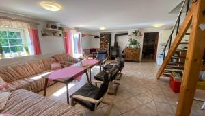 a living room with a couch and a table and chairs at Chata Buchtovna in Rejdice
