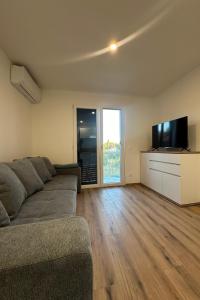 a living room with a couch and a flat screen tv at Apartments and rooms with parking space Starigrad, Paklenica - 24535 in Starigrad-Paklenica
