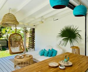 a living room with a table and a couch at Beach Lifestyle Bungalow in Motu Tiahura