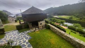 an aerial view of a house with a stone wall and a river at Casa el Curro in Cueva +23 photos