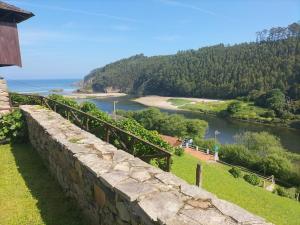 a stone wall with a view of a river at Casa el Curro in Cueva