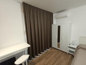 a room with a bed and a window with curtains at Casa Degli Ulivi - Camera in Numana
