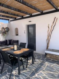 a dining room with a table and chairs at Mazi stin Io in Ios Chora +40 photos