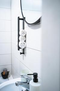 a bathroom with a sink and a mirror and towels at 1 BR Apartment - ZENTRAL - BUSINESS - WIFI - KÜCHE - NETFLIX - PARKHAUS in Wiesbaden