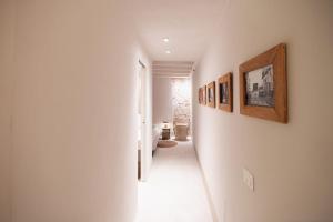 a hallway with pictures on the walls of a house at Loft Serisso in Trapani