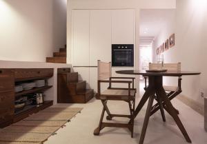 a kitchen with a table and a chair in a room at Loft Serisso in Trapani