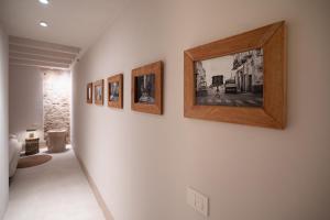 a row of framed pictures on a wall at Loft Serisso in Trapani