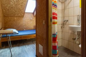 a small bathroom with a bed and a sink at Motel Saunapunkt in Laagri +31 photos