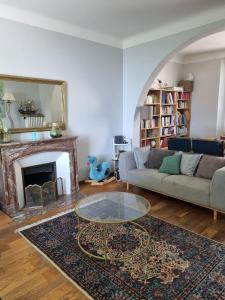 a living room with a couch and a coffee table at Manor house with pool in Le Tignet