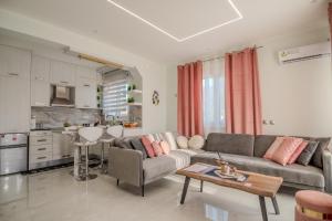 a living room with a couch and a table at Zoi Elegant Apartments Filiatra in Filiatra