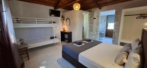 a bedroom with a bed and a room with a bunk bed at Georgia apartments in Stafylos