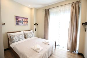 Ένα ή περισσότερα κρεβάτια σε δωμάτιο στο Loutraki Home