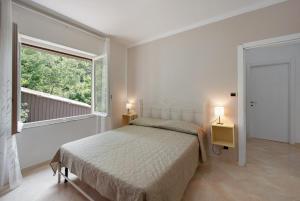 a bedroom with a bed and a large window at Villino Chiara in Pannesi