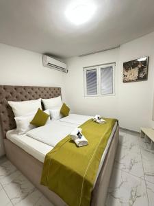 a bedroom with a large bed with a green blanket at La Familia in Šibenik +128 photos