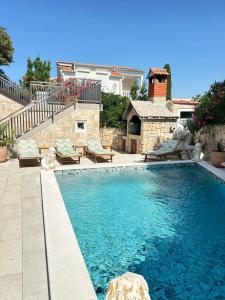 a swimming pool in a yard with a house at La Familia in Šibenik