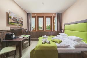 Postel nebo postele na pokoji v ubytování Park Hotel Bükfürdő