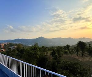 a view of the mountains from a balcony at The Solan Greens in Solan