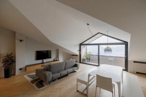 a living room with a couch and a tv at Villa ALMANA in Cernobbio