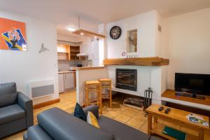 a living room with a couch and a fireplace at Gîte Logement 2/4 personnes - Village de gites des Vignes in Les Vignes