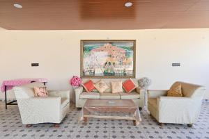a living room with two couches and a painting on the wall at Harnawa Haveli - A Boutique Heritage Stay in Jaipur +109 photos