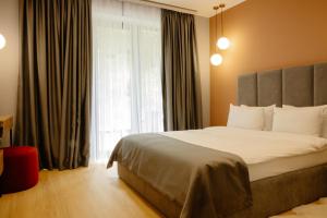 a bedroom with a large bed and a window at Budz Карпати in Bukovel