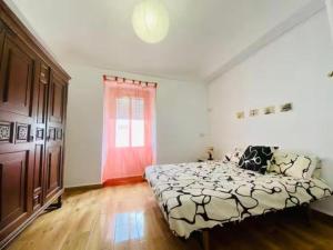 a bedroom with a large bed and a window at Piso con encanto en Santa Amalia in Santa Amalia