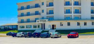 a parking lot with cars parked in front of a building at Sierra in Piteşti