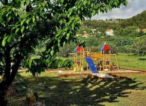 a park with a playground in a field at Krka Magic Pumpkin in Rupe