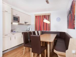 une cuisine et une salle à manger avec une table et des chaises dans l'établissement Apartment in Wald im Pinzgau with Swimming Pool and Views, à Wald im Pinzgau