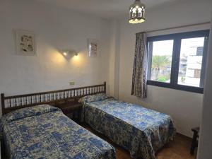 a room with two beds and a window at Costa Luz BL 4 6 in Puerto del Carmen +18 photos