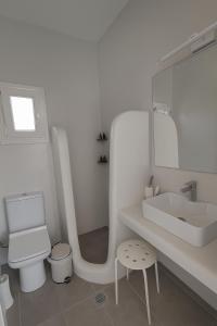 a white bathroom with a sink and a toilet at Seafront Alos Gem - Loutra Seaview Escape in Loutra +11 photos