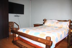 a bedroom with a bed and a flat screen tv at EvehomeStay B&B in Soshanguve