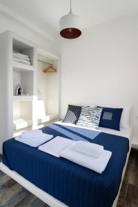 a blue and white bedroom with a large bed at Seafront Alos Gem - Loutra Seaview Escape in Loutra