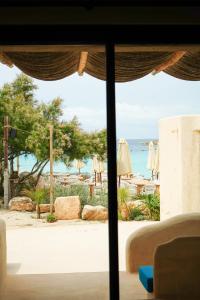 a view of a beach from a room with a window at Hannah Formentera in Playa Migjorn
