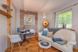 a living room with a white couch and a table at Albatros in Ueckeritz +11 photos