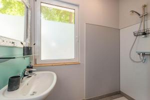 a bathroom with a sink and a window at Albatros in Ueckeritz