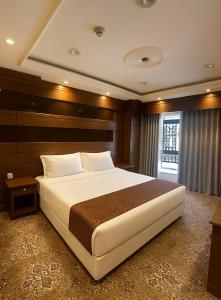 a bedroom with a large bed and a window at اجنحة امجاد السلام طيبة in Medina