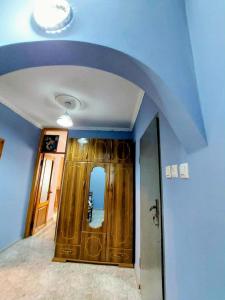a hallway with a door in a room with blue walls at Bina kutaisi zastava in Kutaisi
