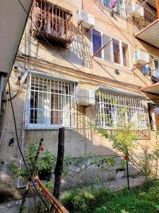 a building with white windows and a balcony at Bina kutaisi zastava in Kutaisi